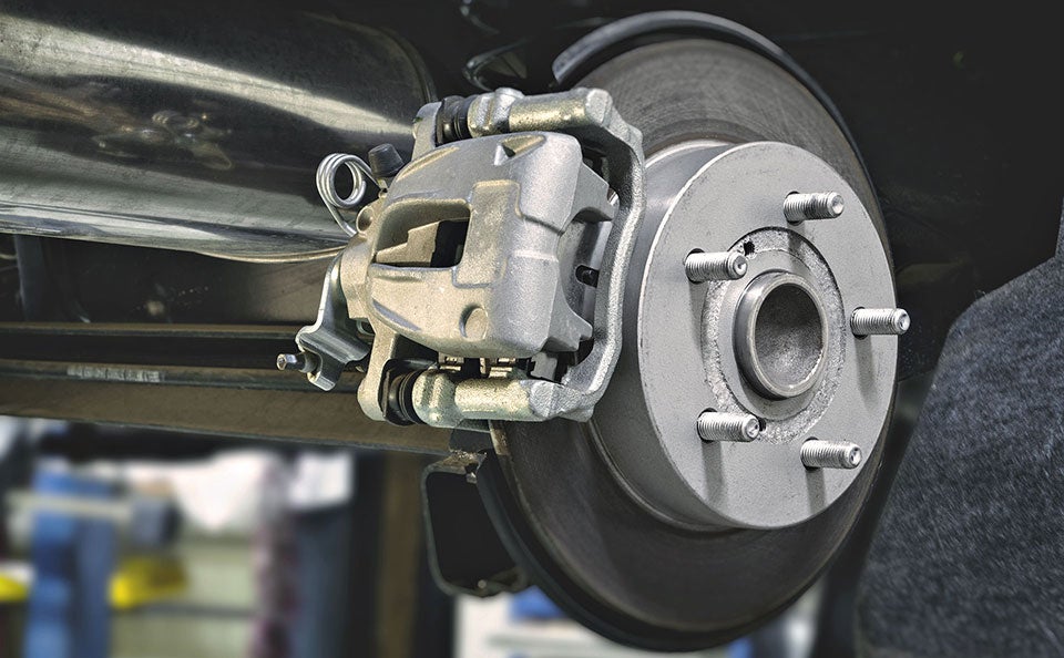 A picture of new brakes applied to a wheel in a certified Chevy service center.
