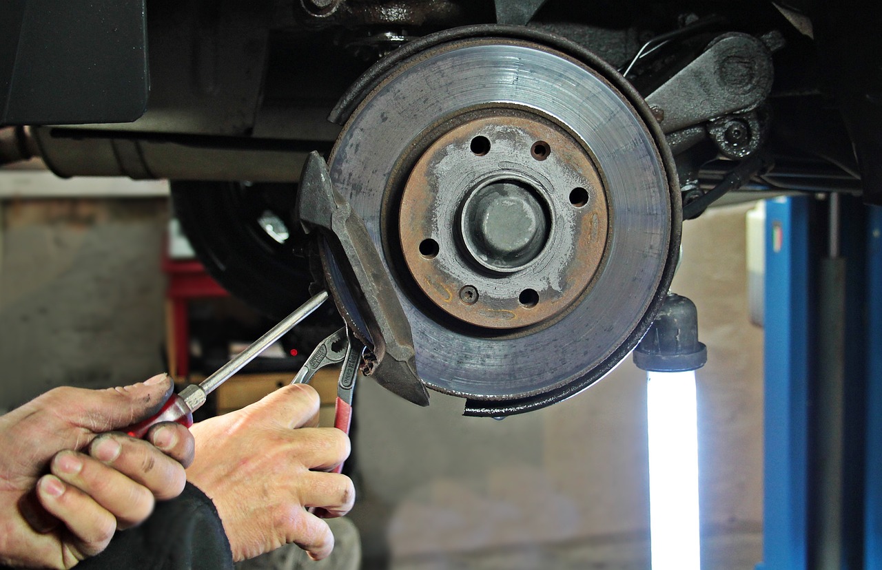 A mechanic working on a car wheel