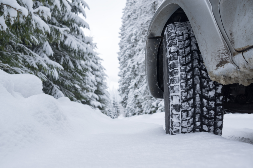 Winter tire tread gripping snow on icy road