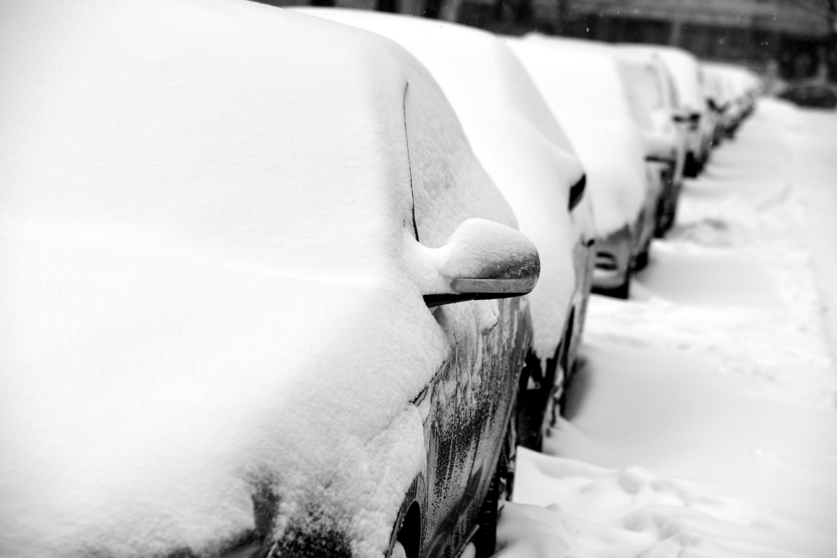 Snow-covered vehicles parked during a Minnesota extreme cold winter